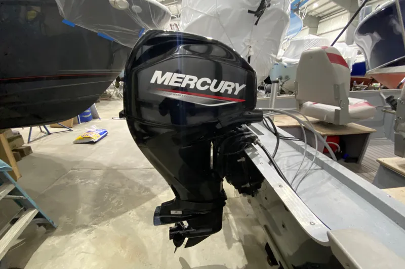 Slide: The Image of 2021 Lund SSV-18 boat with Mercury outboard motor in a storage facility. - 4
