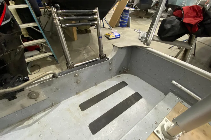 Slide: The Image of Interior of a 2021 Lund SSV-18 boat showing metal flooring and ladder. - 8