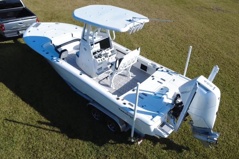 Slide: The Image of 2024 Tidewater 2500 Carolina Bay boat on trailer, parked on grass. - 12