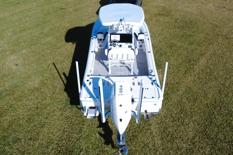 Slide: The Image of 2024 Tidewater 2500 Carolina Bay boat on trailer, parked on grass. - 13