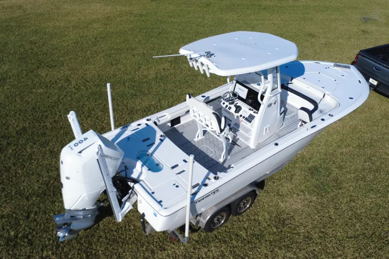 Slide: The Image of 2024 Tidewater 2500 Carolina Bay boat on trailer, parked on grass. - 14