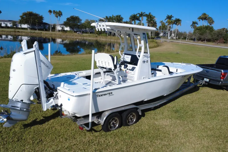 Slide: The Image of 2024 Tidewater 2500 Carolina Bay boat on trailer, parked on grass. - 16