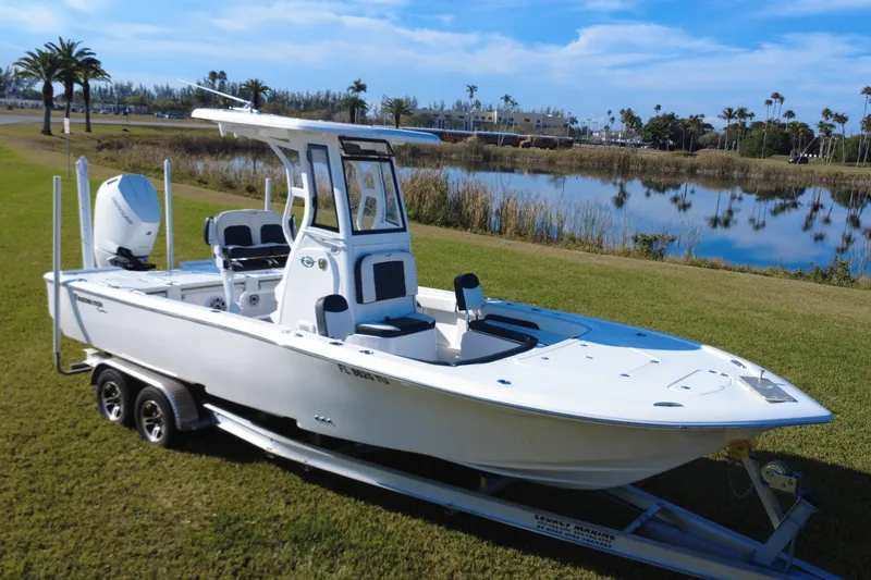 Slide: The Image of 2024 Tidewater 2500 Carolina Bay boat on trailer, displayed on grass. - 17
