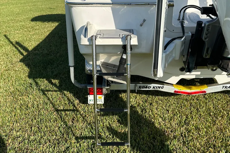 Slide: The Image of 2024 Tidewater 2500 Carolina Bay boat with ladder on grass. - 19