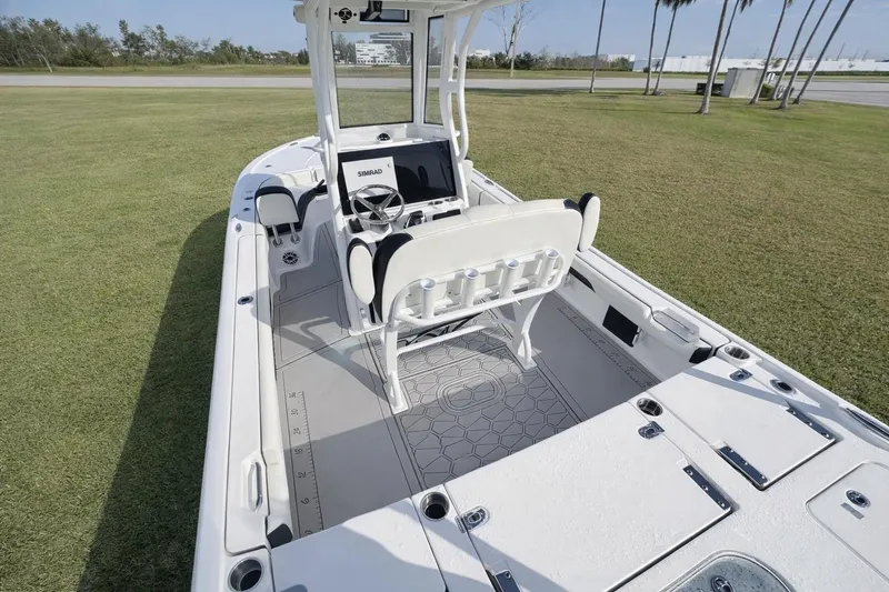 Slide: The Image of 2024 Tidewater 2500 Carolina Bay boat interior with helm, seating, and Simrad electronics. - 20
