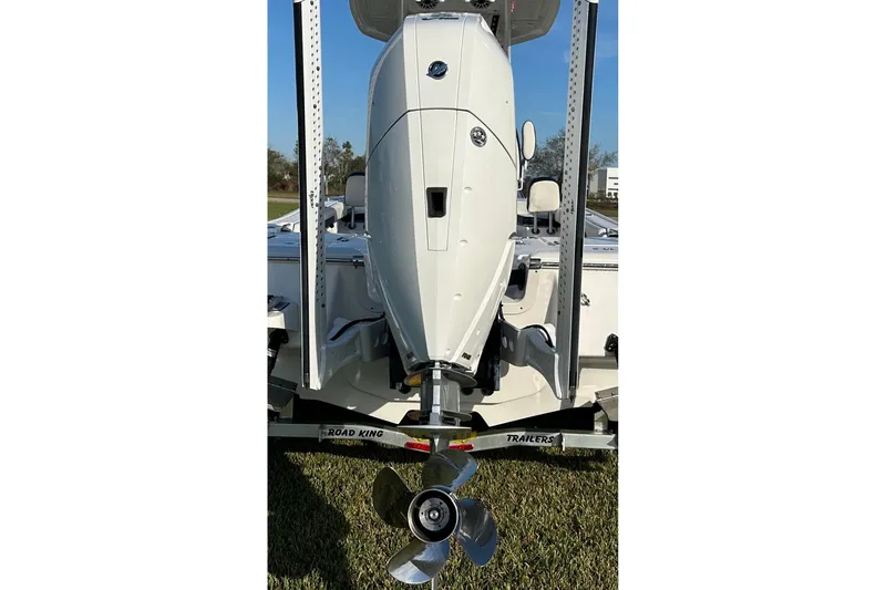 Slide: The Image of 2024 Tidewater 2500 Carolina Bay boat dashboard with steering wheel and electronic controls. - 23