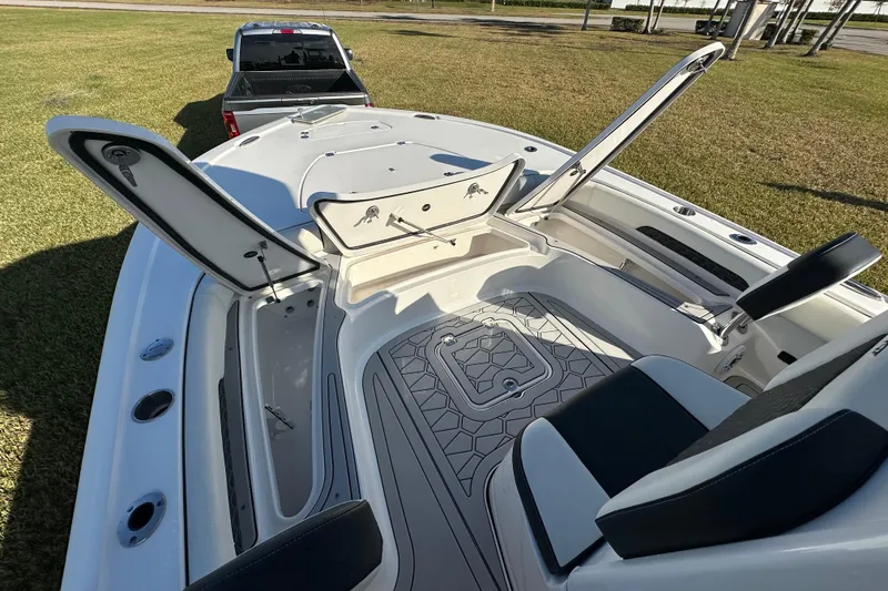 Slide: The Image of 2024 Tidewater 2500 Carolina Bay boat interior with open storage compartments and seating. - 29