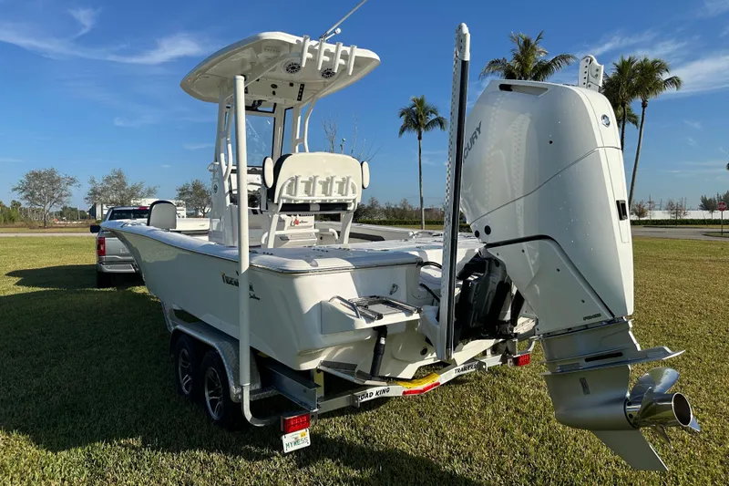 Slide: The Image of 2024 Tidewater 2500 Carolina Bay boat on trailer, featuring a powerful Mercury outboard engine. - 3