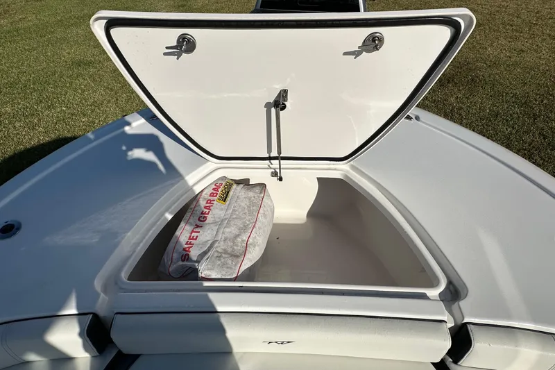 Slide: The Image of 2024 Tidewater 2500 Carolina Bay boat storage compartment with safety gear bag. - 33
