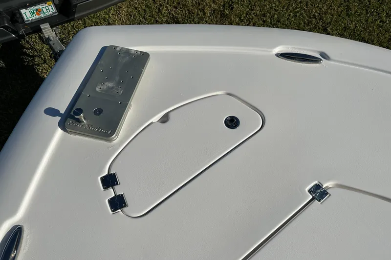 Slide: The Image of 2024 Tidewater 2500 Carolina Bay boat deck with storage hatch and hardware. - 34