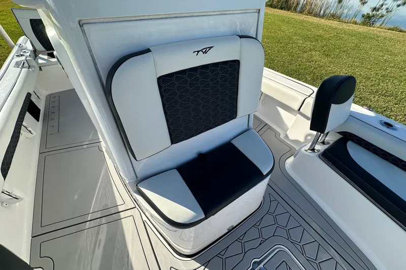 Slide: The Image of 2024 Tidewater 2500 Carolina Bay boat interior with cushioned seating and sleek design. - 38