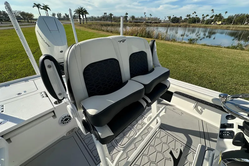 Slide: The Image of 2024 Tidewater 2500 Carolina Bay boat interior with dual seats and Mercury engine. - 42