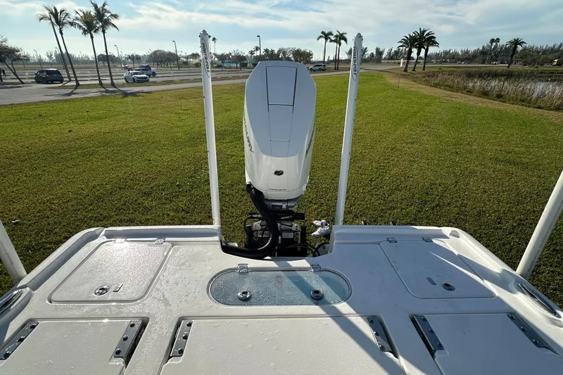 Slide: The Image of 2024 Tidewater 2500 Carolina Bay boat with outboard motor on grassy area. - 45