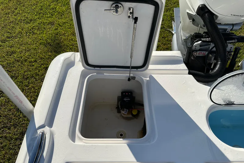 Slide: The Image of Open storage compartment on 2024 Tidewater 2500 Carolina Bay boat, showing interior and engine components. - 47
