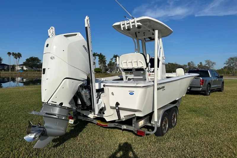 Slide: The Image of 2024 Tidewater 2500 Carolina Bay boat on trailer, parked on grass with clear sky. - 5
