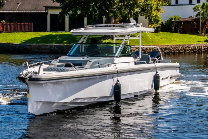 Slide: The Image of 2024 Axopar 37 Sun Top boat cruising on a sunny day. - 3