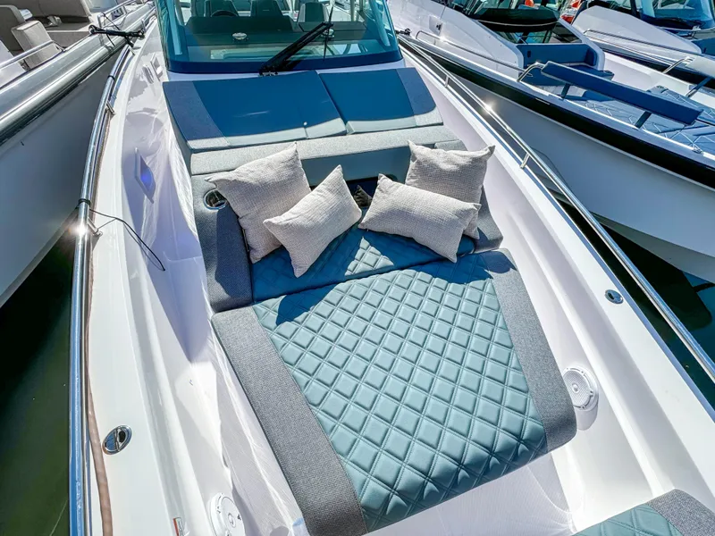 Slide: The Image of 2024 Axopar 37 Sun Top boat with luxurious sunbed and cushions on deck. - 30