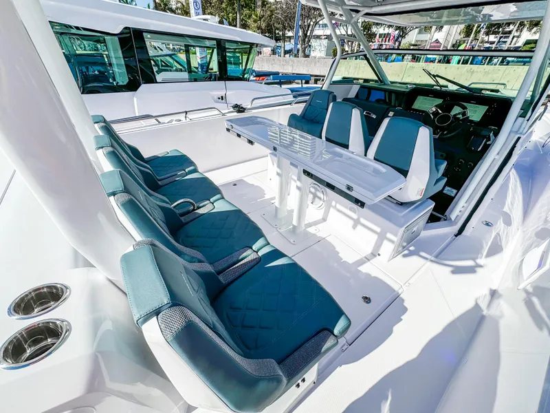 Slide: The Image of 2024 Axopar 37 Sun Top boat interior with teal seating and modern helm. - 15
