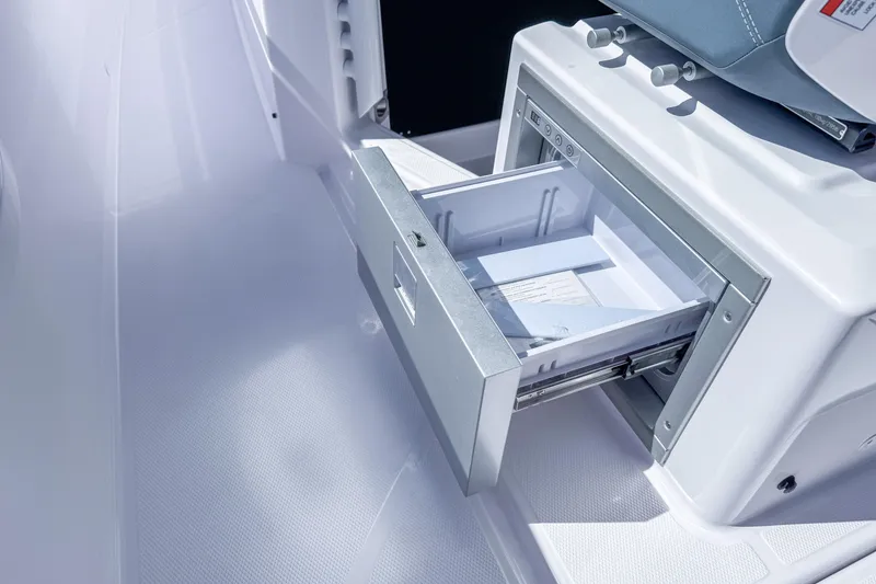 Slide: The Image of 2024 Axopar 37 Sun Top boat interior with open storage drawer. - 18