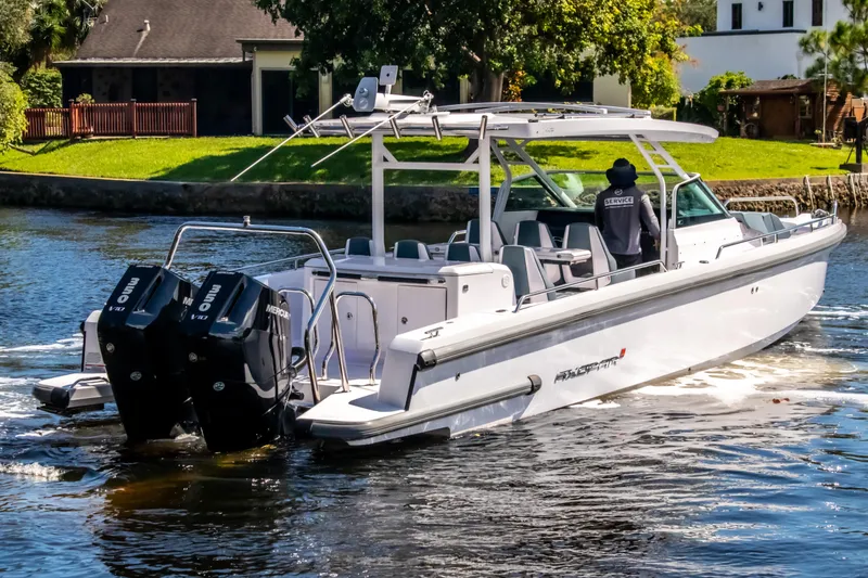 Slide: The Image of 2024 Axopar 37 Sun Top boat cruising on a scenic waterway. - 32