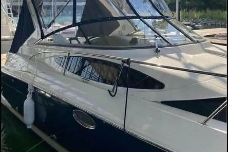 Slide: The Image of 2006 Regal 3060 Window Express boat docked, featuring sleek design and tinted windows. - 1