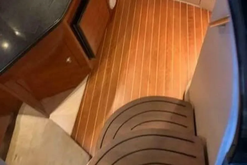 Slide: The Image of Interior of 2006 Regal 3060 Window Express with wood flooring and cabinetry. - 10