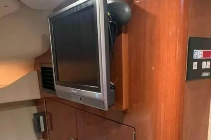 Slide: The Image of Interior of 2006 Regal 3060 Window Express with mounted TV and control panel. - 13