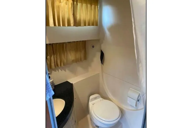 Slide: The Image of Bathroom interior of 2006 Regal 3060 Window Express boat, featuring toilet and sink. - 15