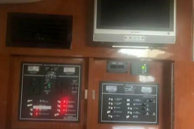 Slide: The Image of Control panel and TV inside a 2006 Regal 3060 Window Express boat. - 16