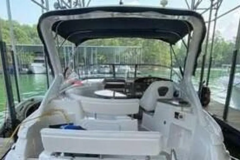 Slide: The Image of 2006 Regal 3060 Window Express boat interior with seating and helm, docked at marina. - 3