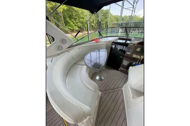 Slide: The Image of 2006 Regal 3060 Window Express boat interior with curved seating and helm. - 6