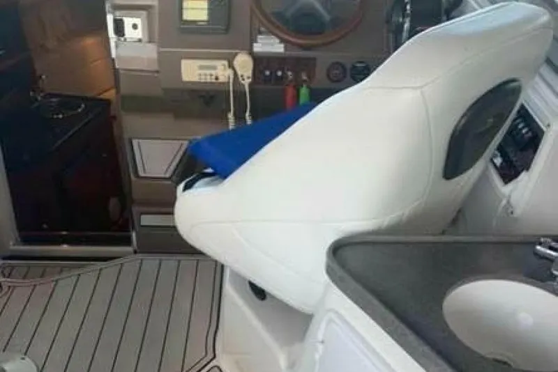 Slide: The Image of Interior of a 2006 Regal 3060 Window Express boat with helm and seating area. - 7