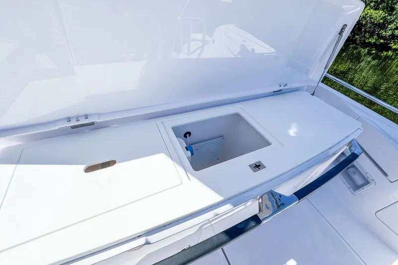 Slide: The Image of 2024 Axopar 37 Sun Top boat storage compartment with open lid. - 14