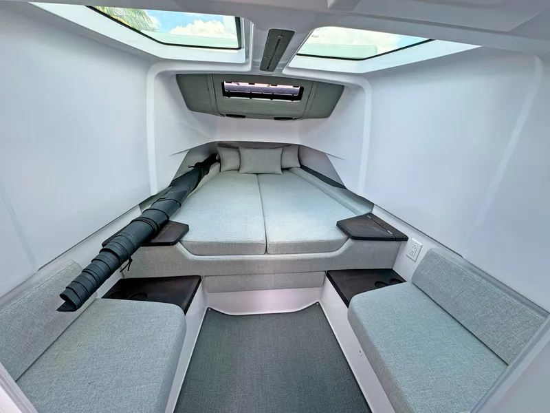 Slide: The Image of 2024 Axopar 37 Sun Top cabin interior with modern seating and skylight. - 22