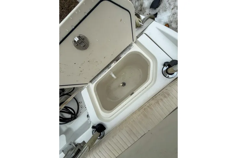 Slide: The Image of Open storage compartment on a 1999 Boston Whaler 18 Dauntless boat. - 13