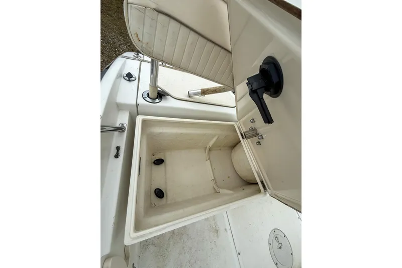 Slide: The Image of 1999 Boston Whaler 18 Dauntless boat storage compartment with open lid and seat. - 14
