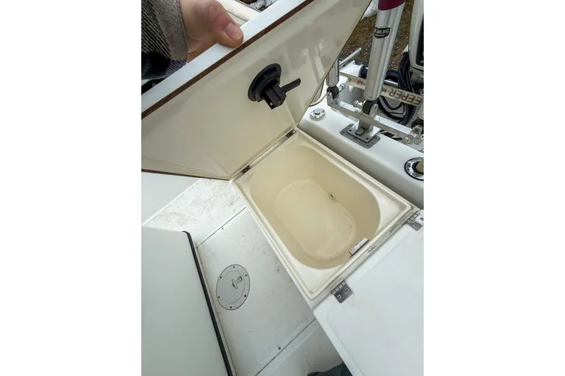 Slide: The Image of Open storage compartment on a 1999 Boston Whaler 18 Dauntless boat. - 15