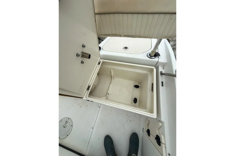 Slide: The Image of Open storage compartment on a 1999 Boston Whaler 18 Dauntless boat. - 16