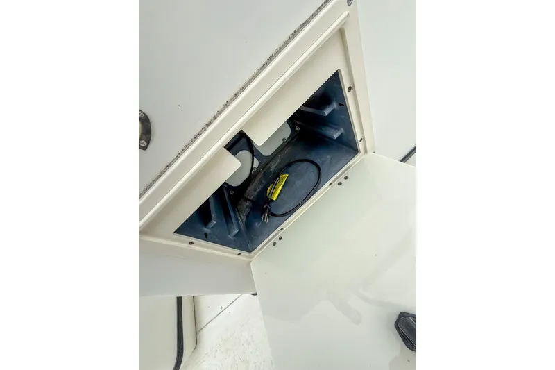 Slide: The Image of Open storage compartment on a 1999 Boston Whaler 18 Dauntless boat. - 17
