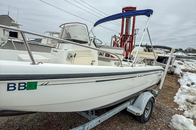 Slide: The Image of 1999 Boston Whaler 18 Dauntless boat on trailer, parked in snowy marina. - 5