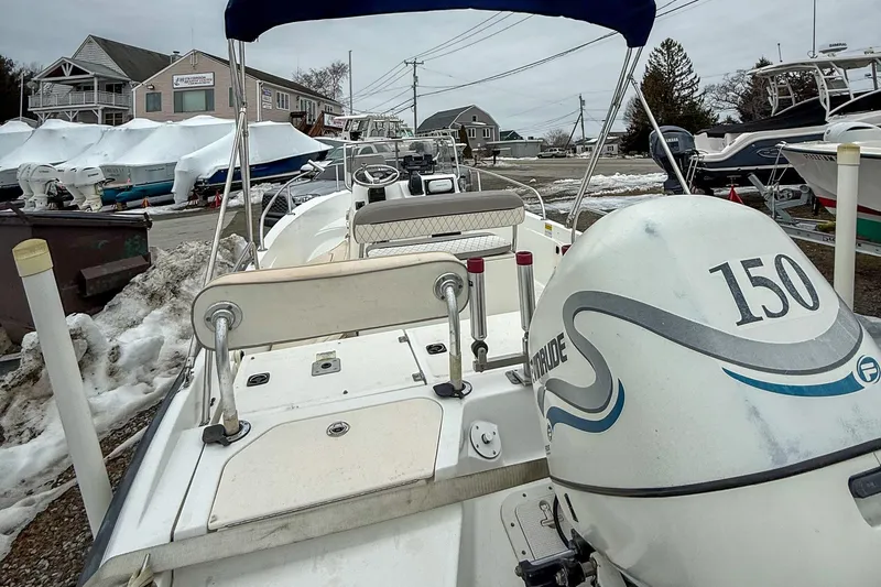 Slide: The Image of 1999 Boston Whaler 18 Dauntless boat with Evinrude 150 engine in snowy marina. - 6
