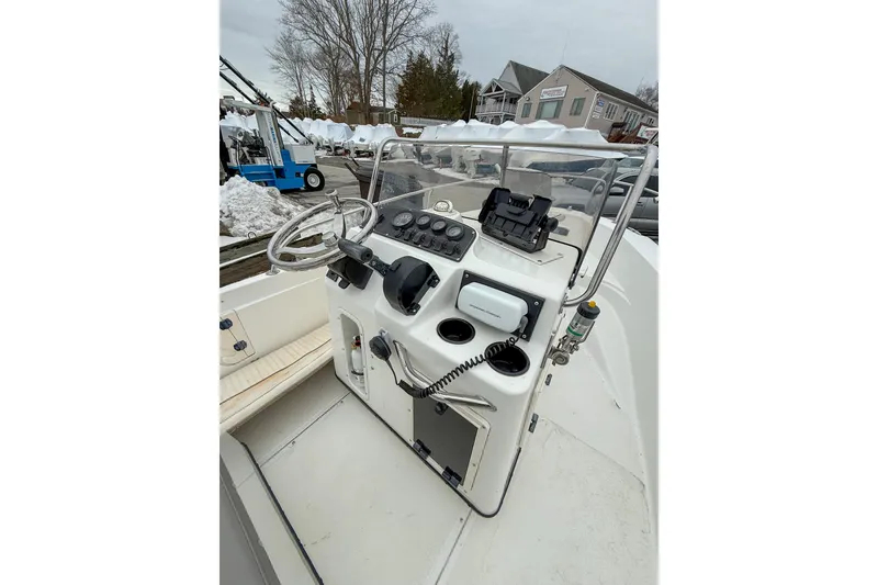 Slide: The Image of 1999 Boston Whaler 18 Dauntless boat console with steering wheel and controls. - 7