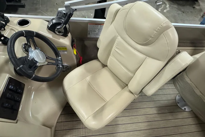 Slide: The Image of 2018 Sylvan Mirage Fish 8522 Party Fish boat helm with beige captain's chair and steering wheel. - 10