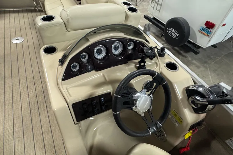 Slide: The Image of 2018 Sylvan Mirage Fish 8522 Party Fish boat dashboard with steering wheel and controls. - 12