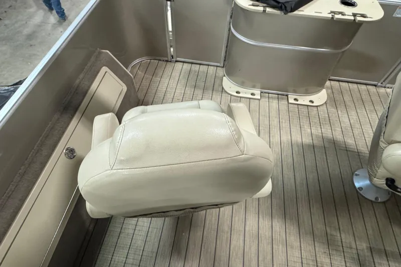 Slide: The Image of 2018 Sylvan Mirage Fish 8522 Party Fish boat interior with beige seating and wood-patterned flooring. - 14