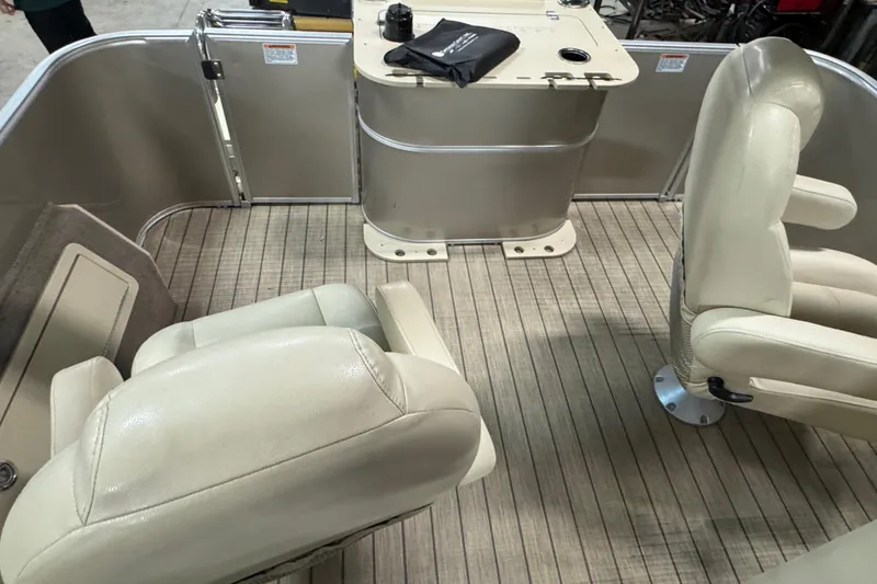 Slide: The Image of 2018 Sylvan Mirage Fish 8522 Party Fish boat interior with beige seating and table. - 15