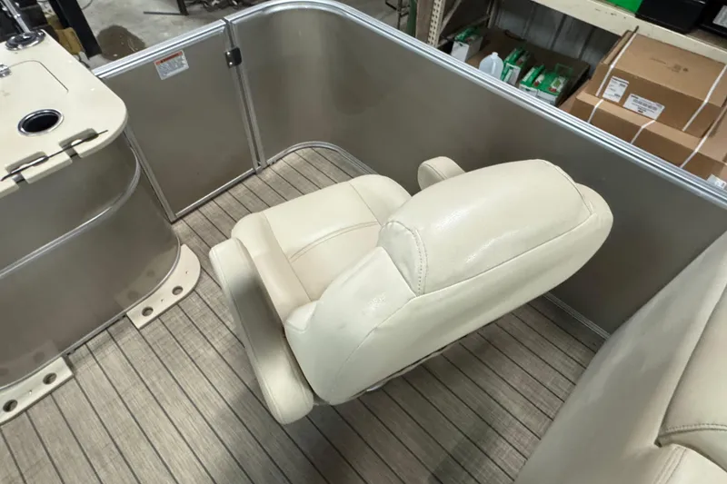 Slide: The Image of 2018 Sylvan Mirage Fish 8522 Party Fish boat interior with beige seating and wood-patterned flooring. - 16