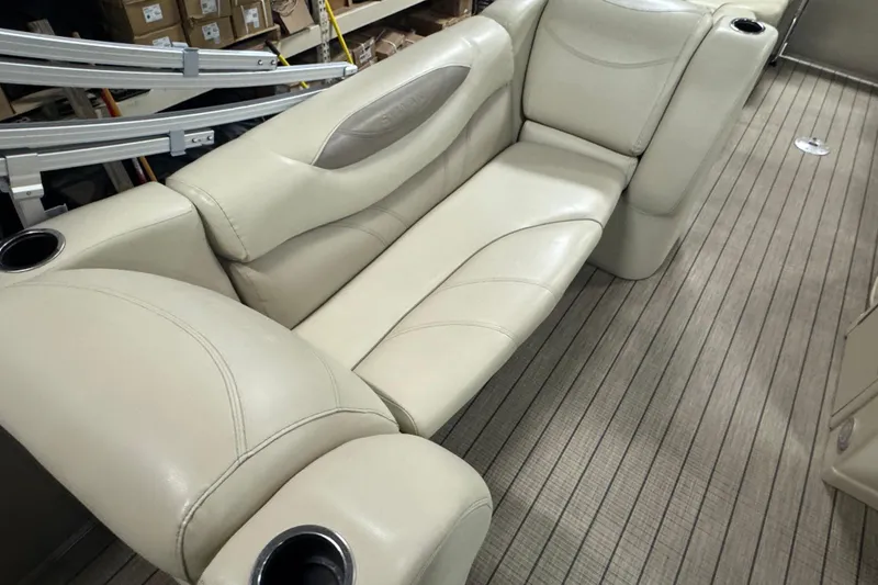 Slide: The Image of 2018 Sylvan Mirage Fish 8522 Party Fish boat interior with beige seating and cup holders. - 18
