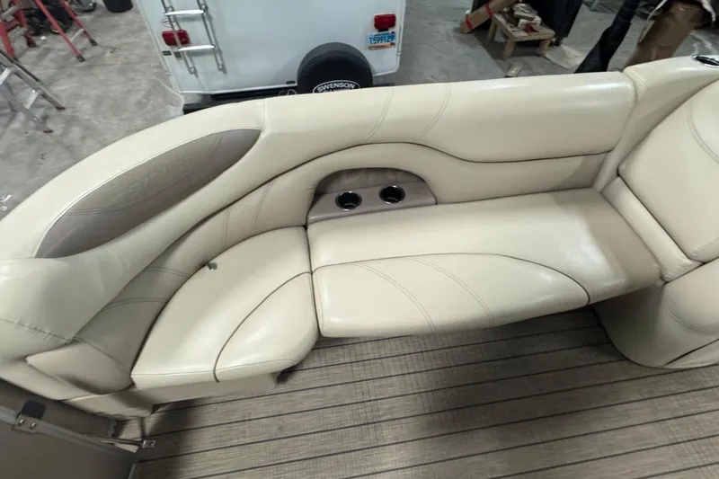 Slide: The Image of 2018 Sylvan Mirage Fish 8522 Party Fish boat interior with beige seating and cup holders. - 7