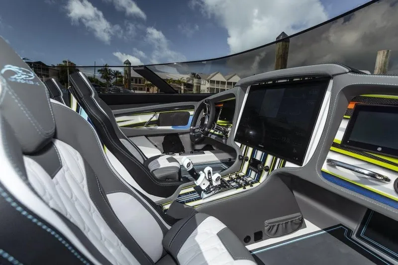 Slide: The Image of Luxurious 2022 MTI 48 boat interior with advanced dashboard and sleek seating design. - 4